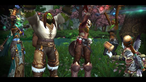 World of Warcraft Screenshot of a bunch of player characters. From left to right, a Troll shaman, Orc death knight, mag'har orc warrior, dracthyr evoker, and a vulpera warrior